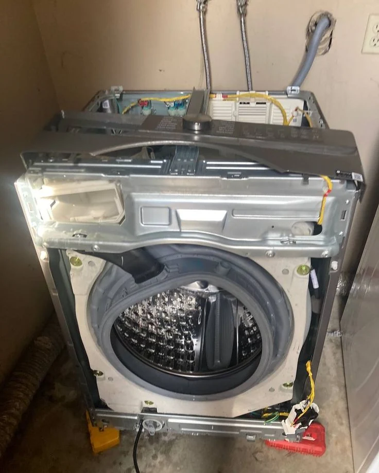Front-load washer with its cabinet removed for inspection